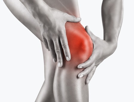 Woman having knee pain isolated on a white background